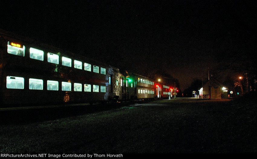 The only light is emitted from the bi-levels as NJT 5737 departs